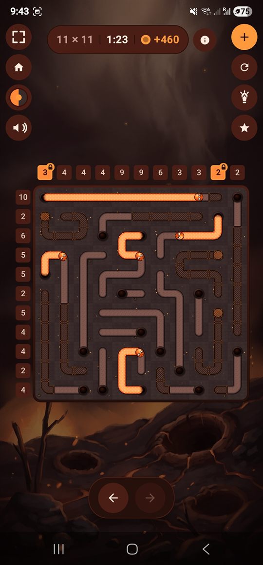 An 11 by 11 board mid-solve in the Ember biome, glowing orange snakes on scorched ground with two clues locked